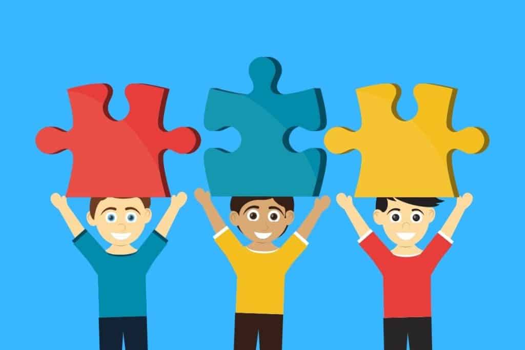 Cartoon graphic of 3 people holding large puzzle pieces above their heads on a blue background.