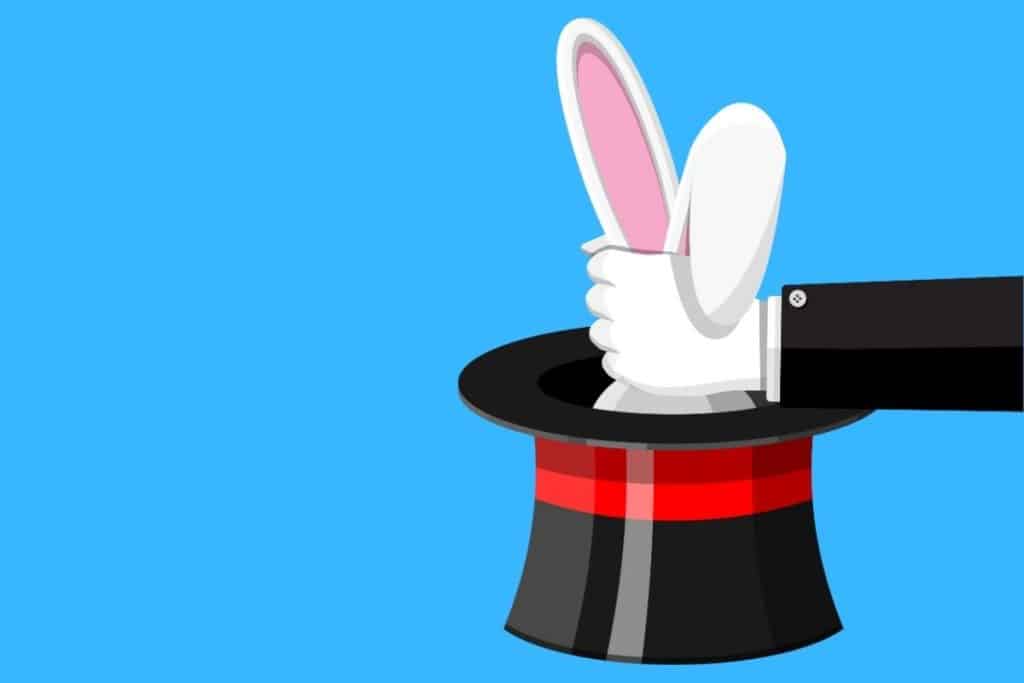 Cartoon graphic of a magic wand, hat and bunny ears coming out of hat being grabbed by magician on a blue background.