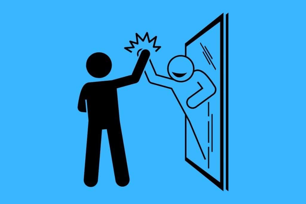 Cartoon graphic of a man high-fiving his reflection coming out of a mirror on a blue background.