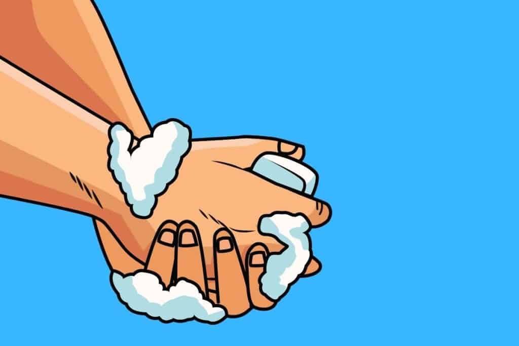 Cartoon graphic of a person washing their hands with soap suds on them on a blue background.