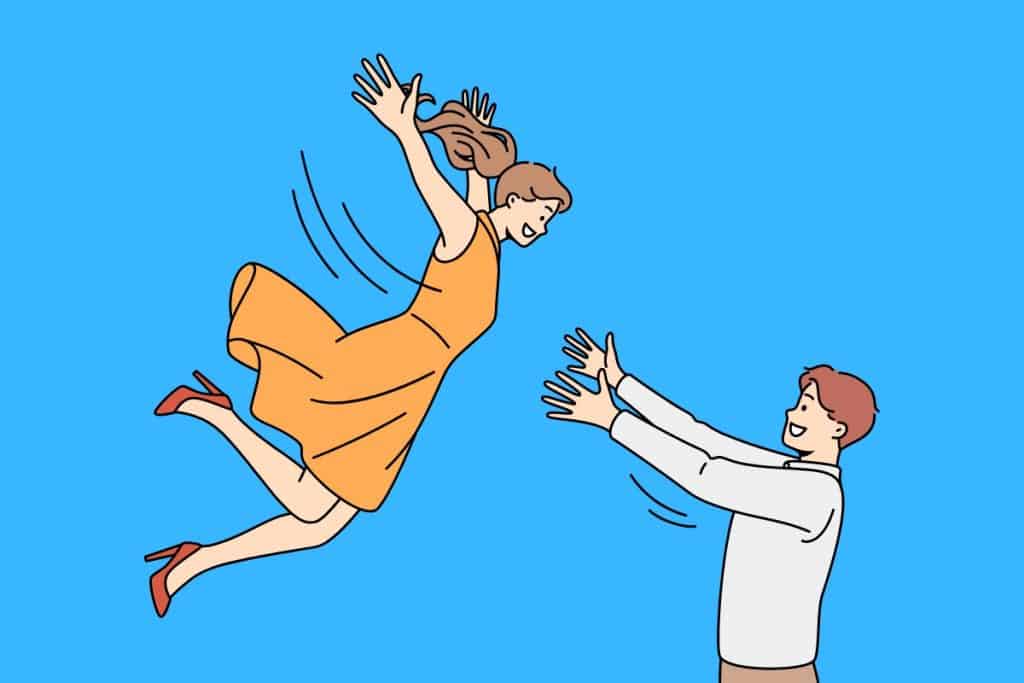 Cartoon graphic of a woman romantically jumping into a mans arms on a blue background.