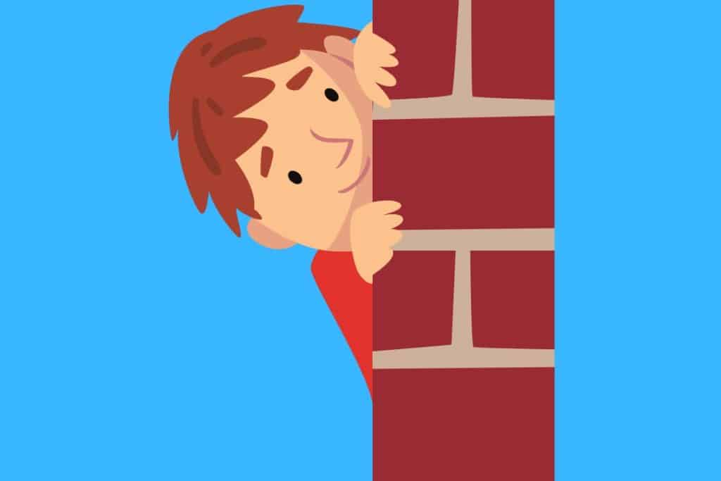 Cartoon graphic of a boy peering around a brick wall on a blue background.